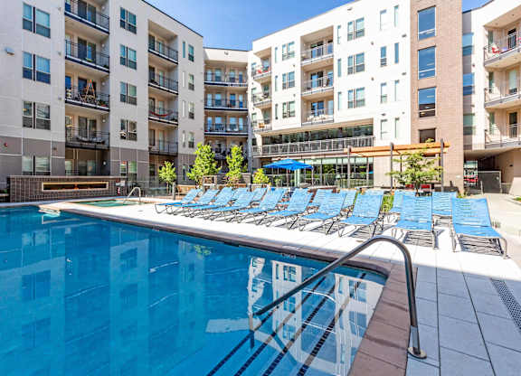 A swimming pool in front of apartment buildings at Regatta Sloans Lake Apartments, Denver