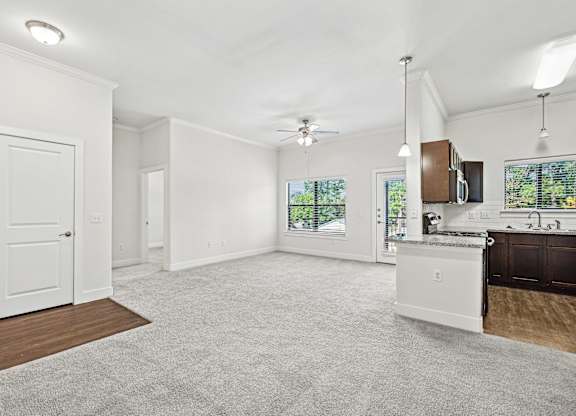Spacious living room with kitchen area at The Laurel at Vintage Park 55+ Apartments, Tomball Texas