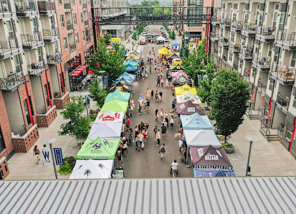 A street market with many people walking around at Regatta Sloans Lake Apartments, Denver, 80204