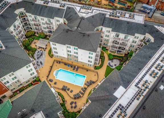 an aerial view of the resort style pool and hot tub at the reserve at south coast apartments at West 130, West Hempstead, 11552