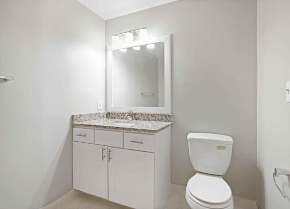 A white toilet sits next to a sink in a bathroom.