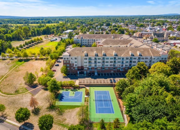 an aerial view of the beautiful property showcasing a half basketball and full tennis court at The Lena, Raritan, New Jersey