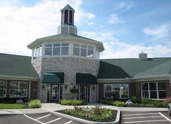 A building with a green roof and a tower on top at The Legends at Steeplechase Apartments, Kentucky