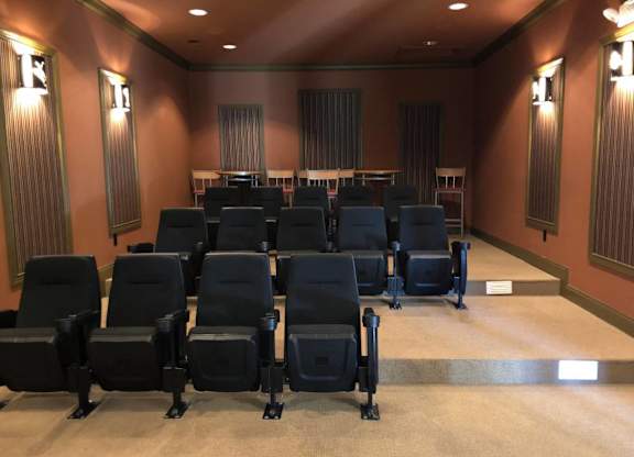 A row of black chairs are arranged in a room with brown walls at The Legends at Steeplechase Apartments, Richwood, 41094