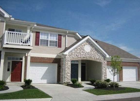 A house with a red door and a white garage door. at The Legends at Steeplechase Apartments, Richwood, 41094