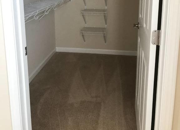 Empty white shelves in a small closet. at The Legends at Steeplechase Apartments, Richwood, KY