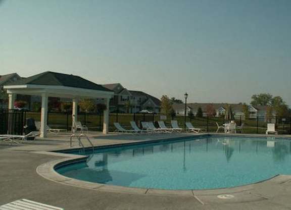 A large swimming pool with a pavilion and sun loungers at The Legends at Steeplechase Apartments, Richwood, Kentucky