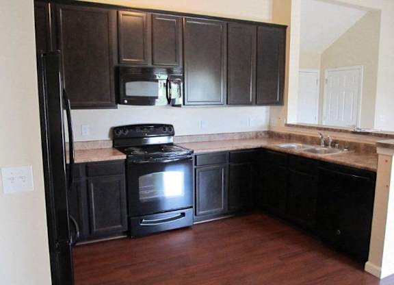 A black kitchen with a stove and microwave at The Legends at Steeplechase Apartments, Kentucky, 41094
