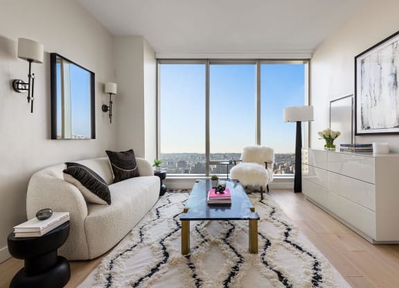 a living room with a view and a couch and a table at The Paxton, New york