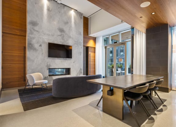 a dining room with a table and chairs in front of a fireplace at The Paxton, New york