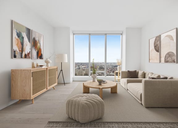 a living room with a couch and a table and a window at The Paxton, New york