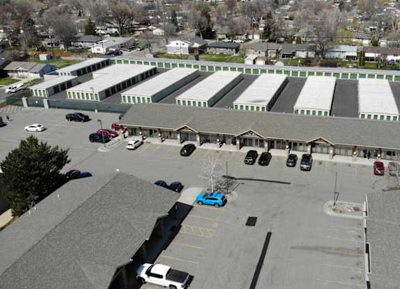 A large building with a parking lot in front.