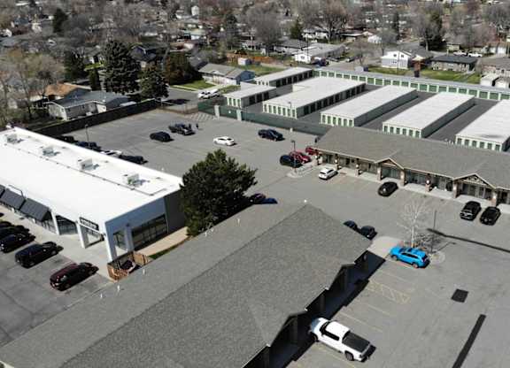 A parking lot with cars and a blue car in the center.