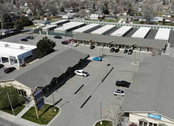 A parking lot with cars and a building in the background.