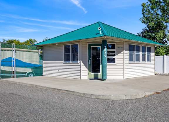 A small building with a green roof and a sign that reads "eagle".