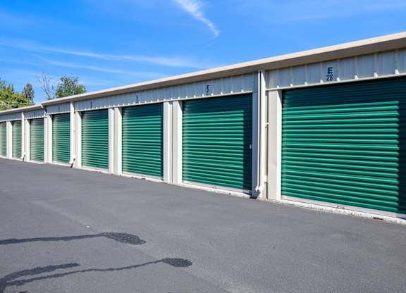 A long row of green storage units with the number 28 visible on the top right.