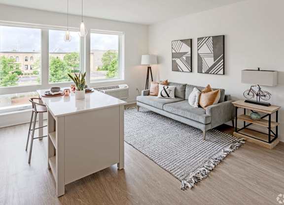 a living room with a couch and a kitchen