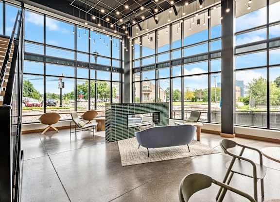 A modern living room with a fireplace and a view of the city.
