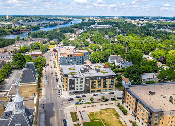 an aerial view of a city with buildings and a river