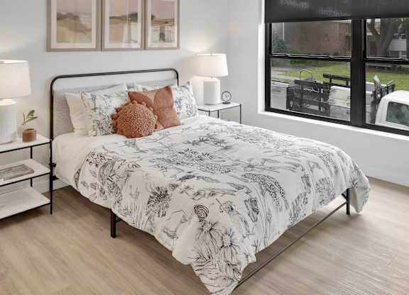 A bedroom with a large bed and a ceiling fan.