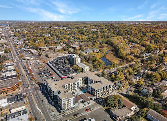 A large building with a parking lot in front of it.