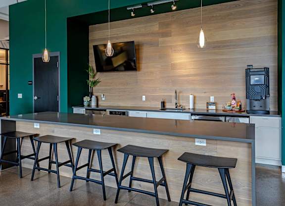a kitchen with a counter and bar stools