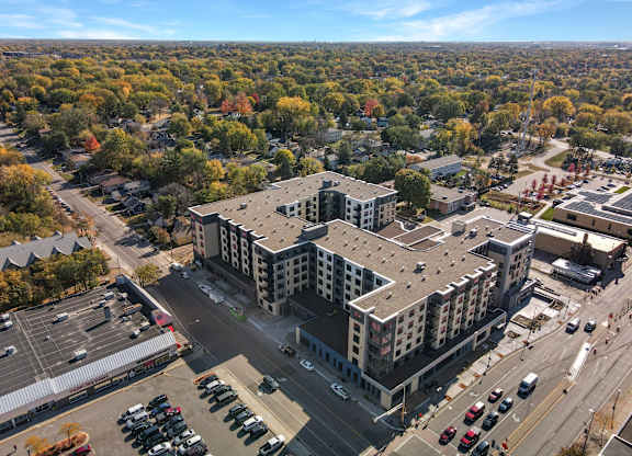 A large building with a parking lot in front of it.