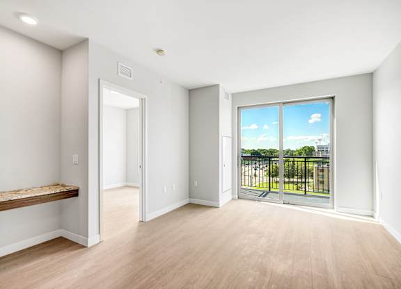 a living room with a large window and a balcony