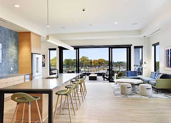 A modern kitchen with a long table and chairs.