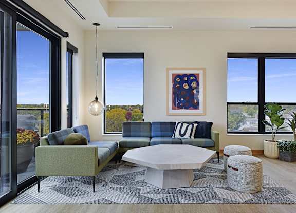 A modern living room with a large window and a view of the outdoors.