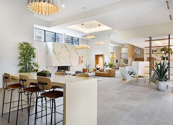 A modern living room with a bar area and a fireplace.