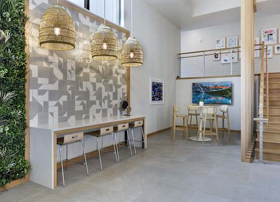 A room with a green wall on the left and a table with chairs in the center.