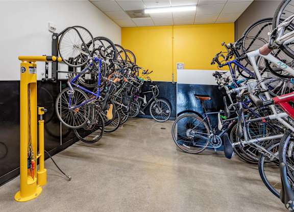 a group of bikes hanging on a wall in a room