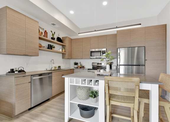 A modern kitchen with wooden cabinets and stainless steel appliances.