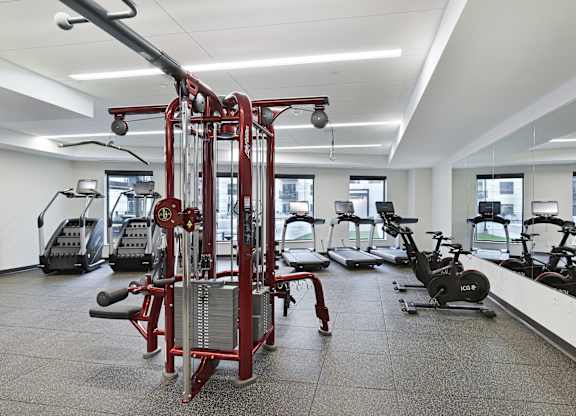 A gym with a variety of equipment including a leg press machine.