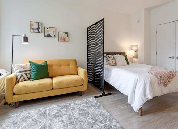 a bedroom with a bed and a couch