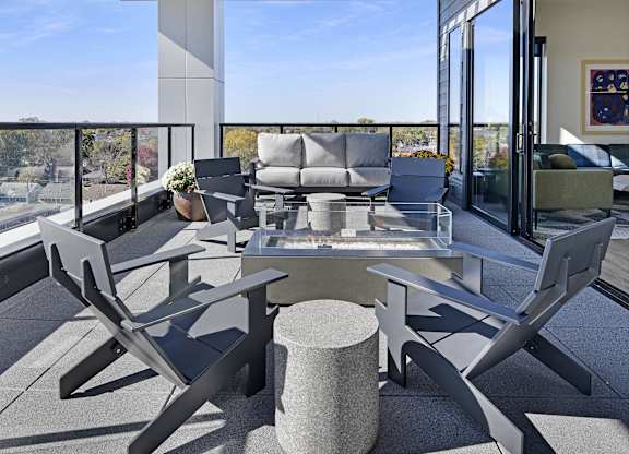 A modern outdoor seating area with a table and chairs.