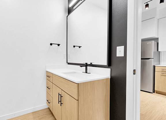 A bathroom with a sink and mirror.