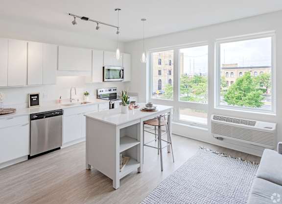 a large white kitchen with a large window
