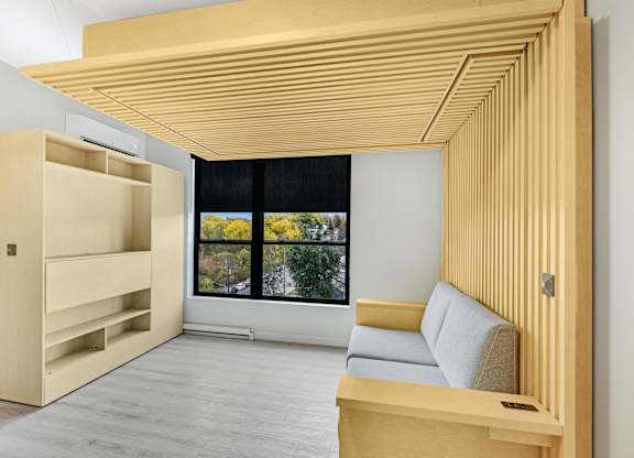 A room with a window and a couch.