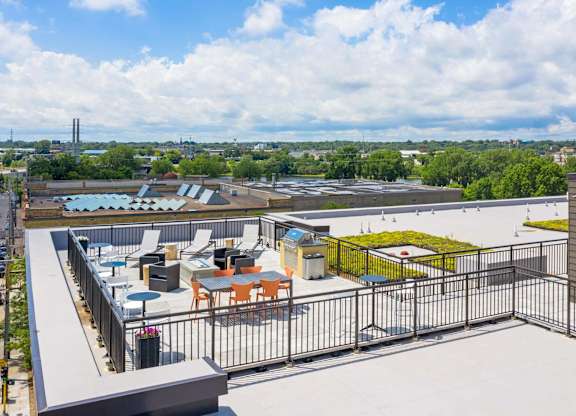 the terrace of a building with tables and chairs on top of a roof