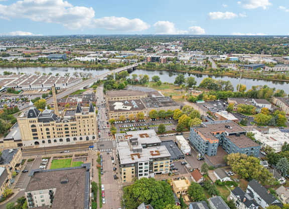 A cityscape with a large building in the center and a river running through it.