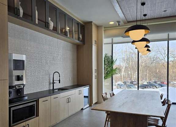A modern kitchen with a large island and wooden cabinets.
