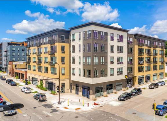 a rendering of a new apartment building on the corner of a city street