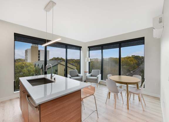 A modern kitchen with a large island and a view of the city.