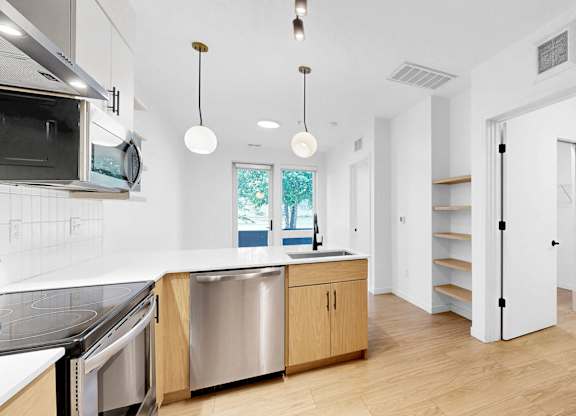 A modern kitchen with wooden cabinets and stainless steel appliances.