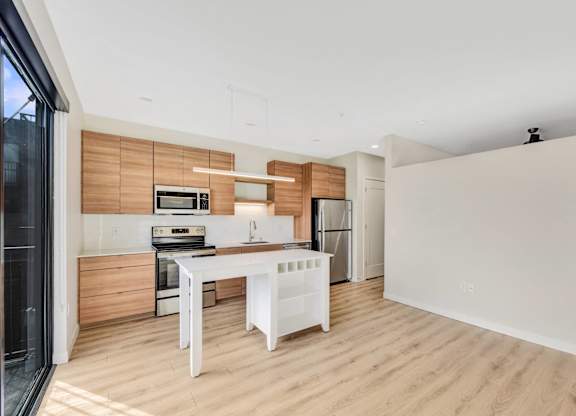 A modern kitchen with wooden accents and white appliances.