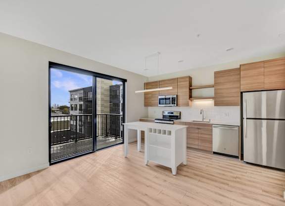 A modern kitchen with a white table and a refrigerator.