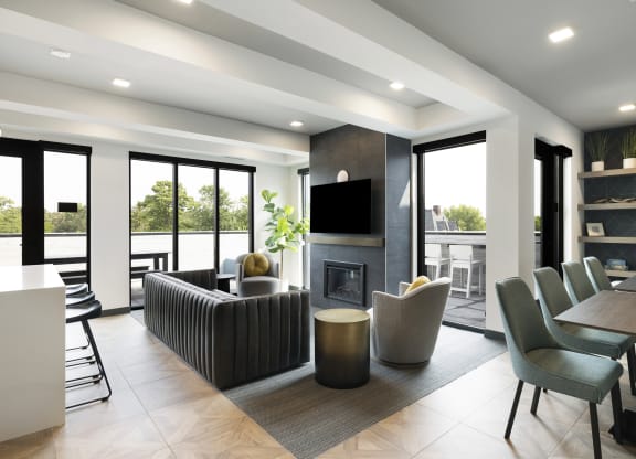 a living room with a fireplace and a table and chairs