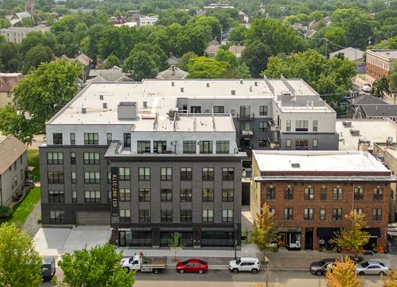 A large building with a parking lot in front of it.